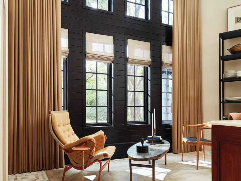 custom tan motorized drapes paired with Roman shades in modern dark wood living space
