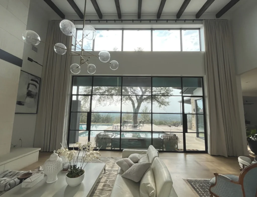 double-height ceiling floor-to-ceiling motorized drapes installed in modern Austin home